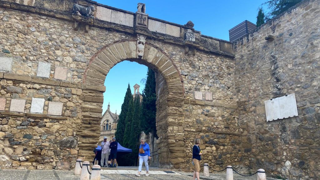 20251105 Turistas junto al Arco de los Gigantes de Antequera, con la Real Colegiata de Santa María la Mayor al fondo
